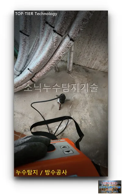 대구 북구 복현동 누수, 은박 보온재 배관 묶음 아래 콘크리트 바닥에 세운 청음 센서와 주황색 본체