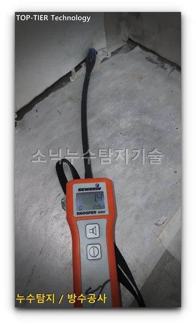 대구 달서구 감삼동 가스 탐지로 누수 지점을 재확인하는 현장, 시멘트 바닥에 놓인 주황색 가스검출기와 벽